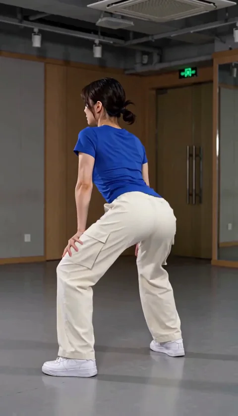 Follow the repeated pelvic pulses and the movement of the trousers. The clip is a generated dance interpretation; inspect the knees, feet and body shape through the full shot. The model changed the hairstyle and studio in this take. (1/3)
